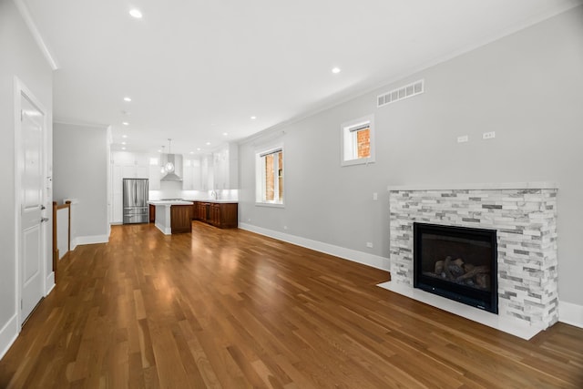 4133 N Kenmore Ave Unit 1N, Chicago, IL 60613 - unfurnished living room featuring crown molding, a fireplace, dark wood-style floors, and recessed lighting