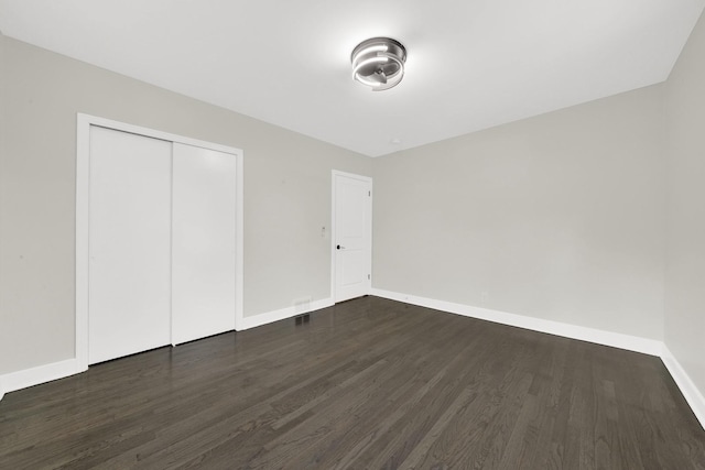 122 Tower Rd, Barrington, IL 60010 - unfurnished bedroom with dark wood-style flooring and a closet