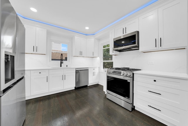 122 Tower Rd, Barrington, IL 60010 - kitchen with appliances with stainless steel finishes, dark wood finished floors, light countertops, white cabinetry, and recessed lighting