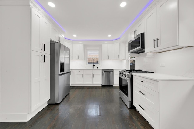 122 Tower Rd, Barrington, IL 60010 - kitchen with appliances with stainless steel finishes, recessed lighting, dark wood-style floors, and white cabinetry