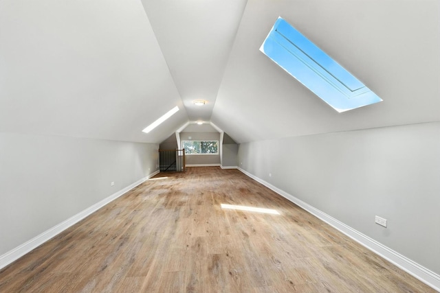 2407 S 60th Ct, Cicero, IL 60804 - additional living space with a skylight, vaulted ceiling, and wood finished floors