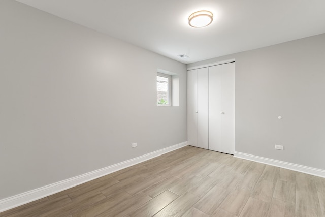 2407 S 60th Ct, Cicero, IL 60804 - unfurnished bedroom with light wood-type flooring and a closet
