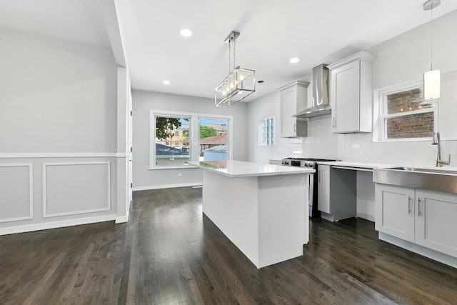2407 S 60th Ct, Cicero, IL 60804 - kitchen featuring stainless steel range, wall chimney exhaust hood, light countertops, a chandelier, and dark wood-style floors