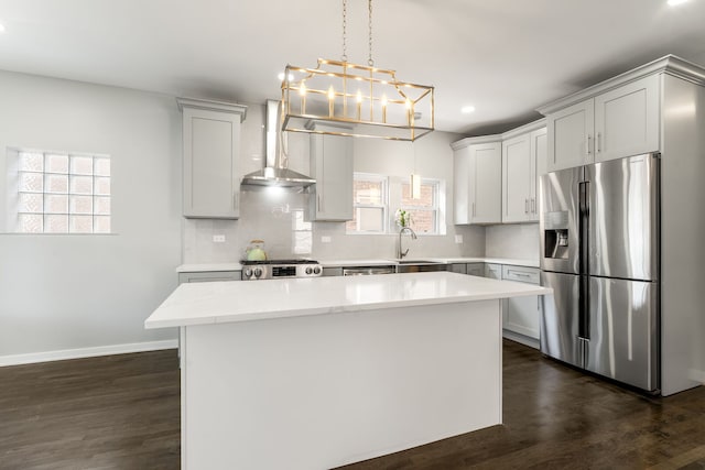 2407 S 60th Ct, Cicero, IL 60804 - kitchen featuring stainless steel appliances, wall chimney range hood, a kitchen island, plenty of natural light, and recessed lighting