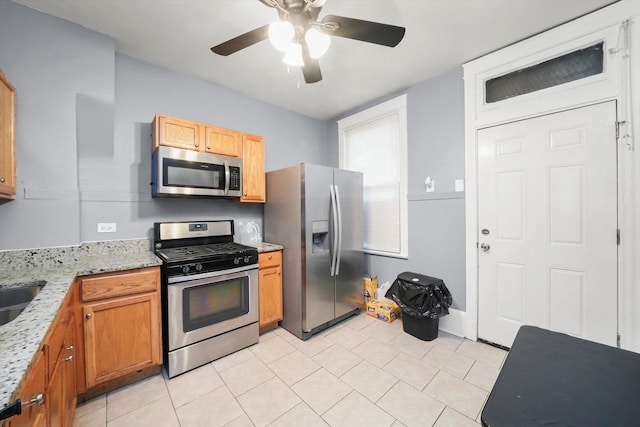 7144 S Champlain Ave, Chicago, IL 60619 - kitchen featuring stainless steel appliances, a ceiling fan, light tile patterned flooring, and light stone countertops