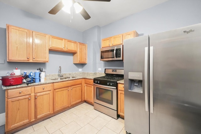7144 S Champlain Ave, Chicago, IL 60619 - kitchen with stainless steel appliances, ceiling fan, light tile patterned floors, and light brown cabinetry