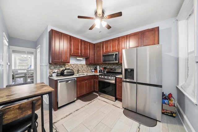 7144 S Champlain Ave, Chicago, IL 60619 - kitchen with stainless steel appliances, light countertops, a ceiling fan, and tasteful backsplash