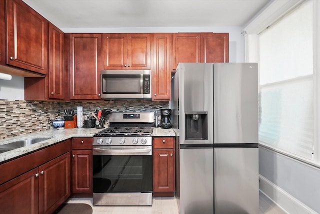 7144 S Champlain Ave, Chicago, IL 60619 - kitchen featuring appliances with stainless steel finishes, tasteful backsplash, light stone counters, and dark brown cabinets