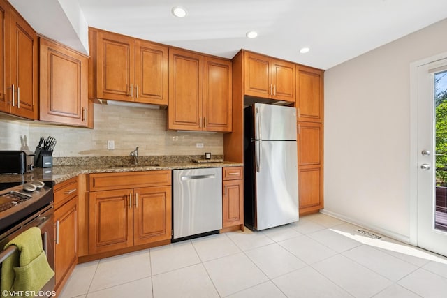3843 Appian Way, Glenview, IL 60025 - kitchen with appliances with stainless steel finishes, brown cabinetry, light stone countertops, decorative backsplash, and recessed lighting