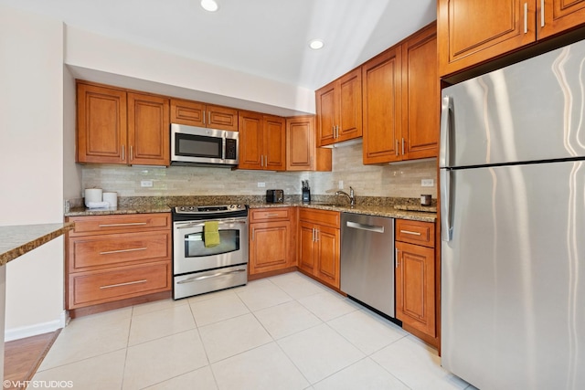3843 Appian Way, Glenview, IL 60025 - kitchen featuring stainless steel appliances, brown cabinets, dark stone counters, backsplash, and recessed lighting