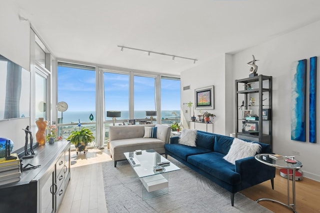 1201 S Prairie Ave Unit 5004, Chicago, IL 60605 - living area featuring rail lighting, expansive windows, light wood-type flooring, healthy amount of natural light, and a water view