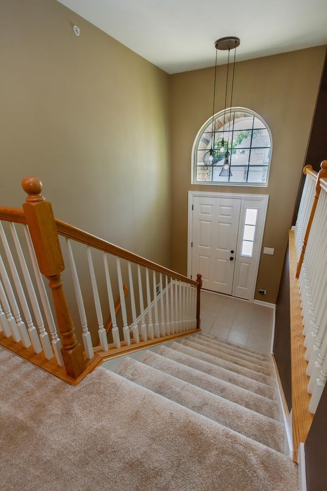 2746 Acorn Ct Unit 2746, West Dundee, IL 60118 - tiled entrance foyer with carpet flooring, stairs, and a chandelier