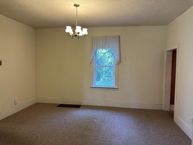 12851 Argo Fay Rd, Thomson, IL 61285 - spare room with carpet flooring, a textured ceiling, and a chandelier