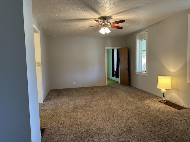 12851 Argo Fay Rd, Thomson, IL 61285 - unfurnished room featuring carpet flooring, a textured ceiling, and ceiling fan