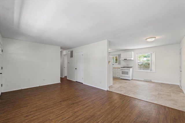 1807 Broadmoor Dr, Champaign, IL 61821 - unfurnished living room featuring wood finished floors and baseboards