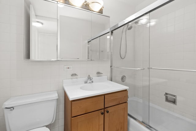 655 W Irving Park Rd Unit 4417, Chicago, IL 60613 - bathroom featuring vanity, enclosed tub / shower combo, and tile walls