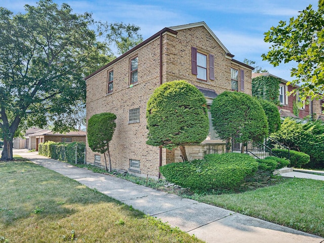 10458 S Forest Ave, Chicago, IL 60628 - view of property exterior with brick siding and a lawn