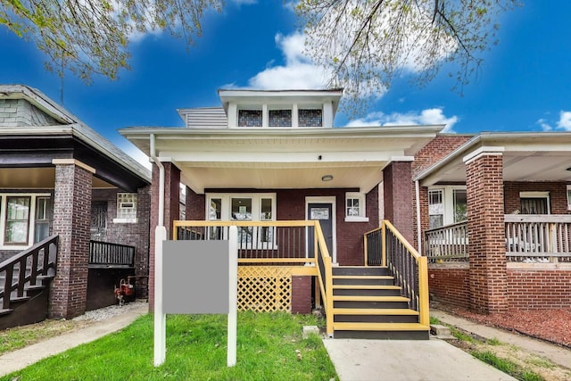 7716 S Rhodes Ave, Chicago, IL 60619 - view of front facade featuring a porch, brick siding, and stairs