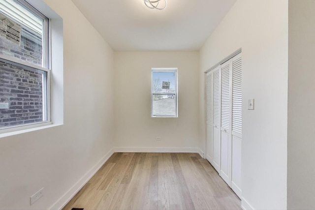 7716 S Rhodes Ave, Chicago, IL 60619 - unfurnished bedroom featuring light wood-style flooring and a closet