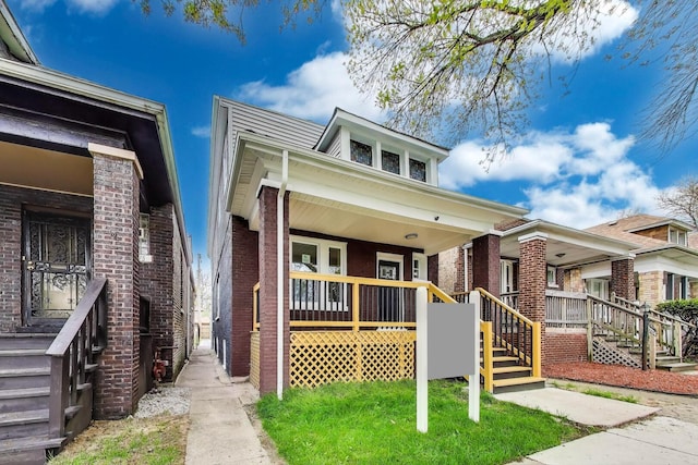 7716 S Rhodes Ave, Chicago, IL 60619 - bungalow-style house with a porch, brick siding, and stairs