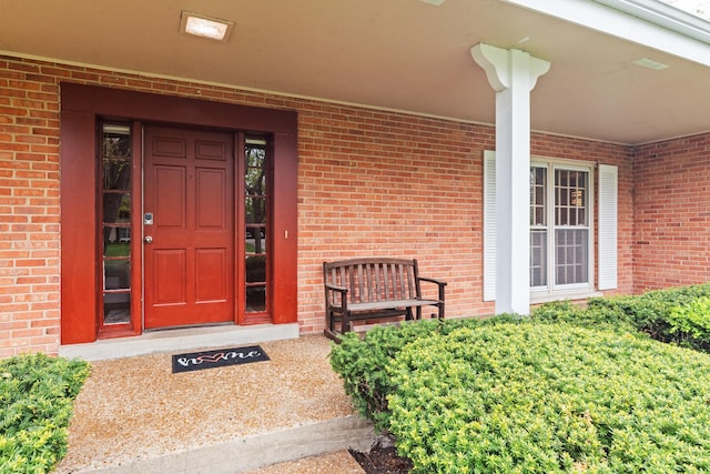 49 Red Oak Ln, Highland Park, IL 60035 - view of exterior entry featuring brick siding and a porch