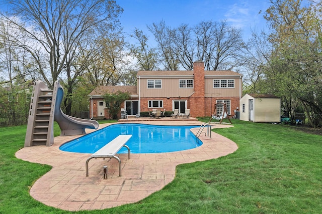 49 Red Oak Ln, Highland Park, IL 60035 - swimming pool featuring a patio area, a storage unit, a water slide, a diving board, and a yard