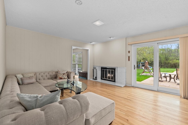 49 Red Oak Ln, Highland Park, IL 60035 - living area featuring wood finished floors, a fireplace, and a textured ceiling
