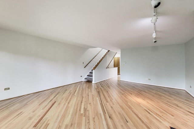 108 Bishop Quarter Ln, Oak Park, IL 60302 - unfurnished living room with rail lighting, stairs, and wood finished floors