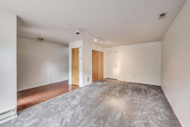 108 Bishop Quarter Ln, Oak Park, IL 60302 - carpeted empty room featuring rail lighting, a baseboard radiator, and tile patterned flooring