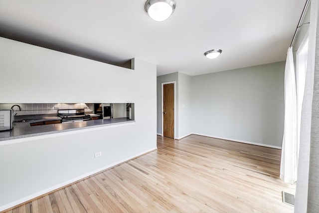 108 Bishop Quarter Ln, Oak Park, IL 60302 - kitchen with appliances with stainless steel finishes, wood finished floors, and backsplash