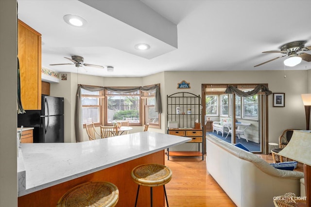 872 Shady Ln, Aurora, IL 60506 - kitchen with ceiling fan, freestanding refrigerator, a peninsula, brown cabinetry, and recessed lighting