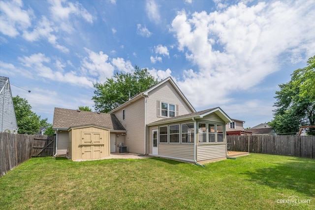 872 Shady Ln, Aurora, IL 60506 - back of property with a storage shed, a sunroom, and a fenced backyard