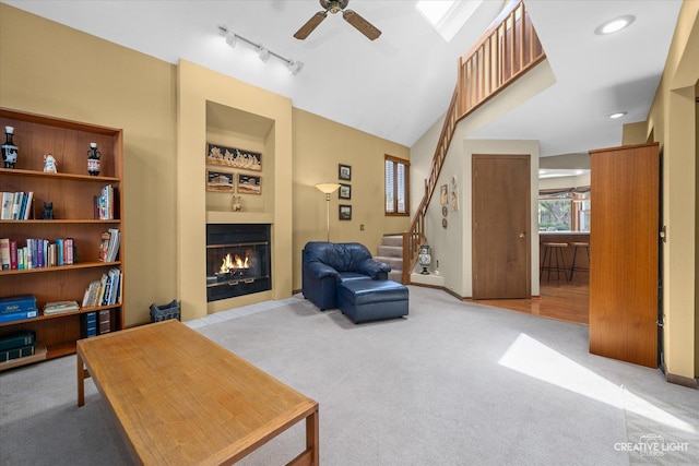 872 Shady Ln, Aurora, IL 60506 - living room featuring light carpet, ceiling fan, stairway, a glass covered fireplace, and built in features