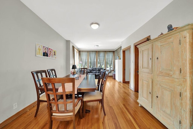 3408 W Marquette Rd, Chicago, IL 60629 - dining space featuring light wood-style flooring and baseboards