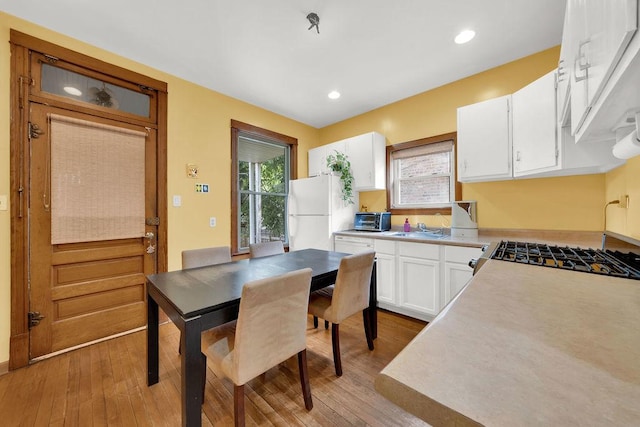 3408 W Marquette Rd, Chicago, IL 60629 - kitchen with freestanding refrigerator, hardwood / wood-style floors, white cabinetry, light countertops, and recessed lighting