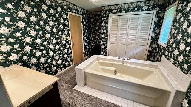 16179 Greenland Dr, Morrison, IL 61270 - bathroom with wallpapered walls, a bath, a closet, and vanity