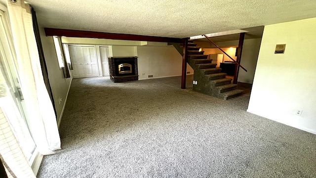 16179 Greenland Dr, Morrison, IL 61270 - unfurnished living room with carpet flooring, stairway, a textured ceiling, and a brick fireplace