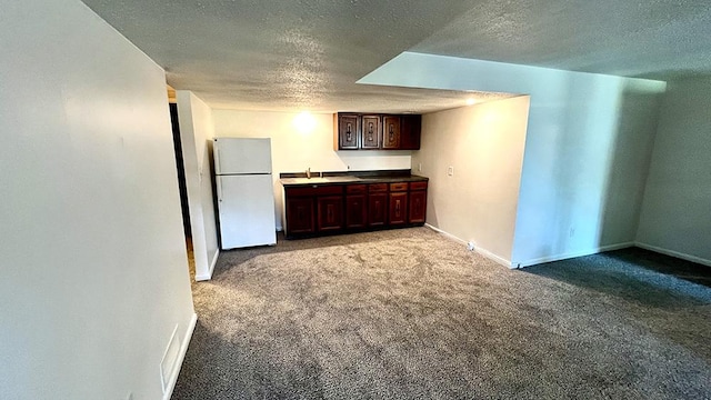 16179 Greenland Dr, Morrison, IL 61270 - kitchen featuring freestanding refrigerator, a textured ceiling, carpet, and dark brown cabinets