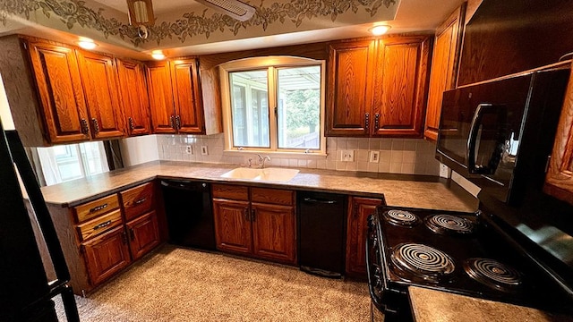 16179 Greenland Dr, Morrison, IL 61270 - kitchen featuring black appliances, decorative backsplash, light countertops, and brown cabinetry