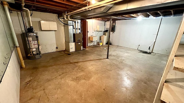 16179 Greenland Dr, Morrison, IL 61270 - unfinished basement featuring gas water heater, heating unit, and electric panel
