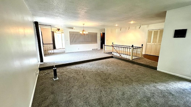 16179 Greenland Dr, Morrison, IL 61270 - unfurnished room featuring carpet floors, a chandelier, and a textured ceiling