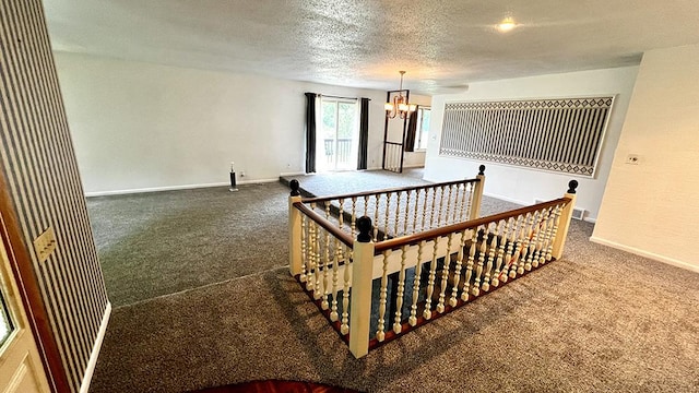 16179 Greenland Dr, Morrison, IL 61270 - empty room featuring carpet, a chandelier, and a textured ceiling