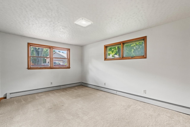 144 Greenley St, Woodstock, IL 60098 - empty room with a baseboard radiator, light carpet, healthy amount of natural light, and a textured ceiling