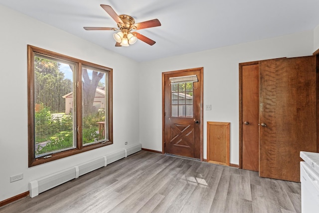 144 Greenley St, Woodstock, IL 60098 - entryway with a baseboard heating unit, light wood-style flooring, and ceiling fan
