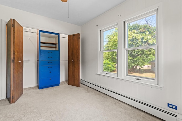144 Greenley St, Woodstock, IL 60098 - unfurnished bedroom with a baseboard radiator, light carpet, multiple windows, and a closet