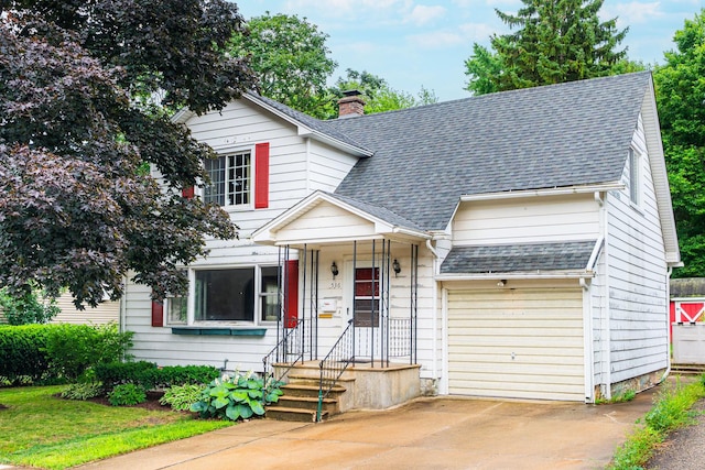 536 Center Ave, Sycamore, IL 60178 - view of front of house with driveway, a shingled roof, and a chimney