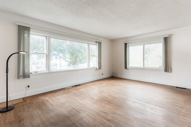 536 Center Ave, Sycamore, IL 60178 - spare room with wood finished floors and a textured ceiling