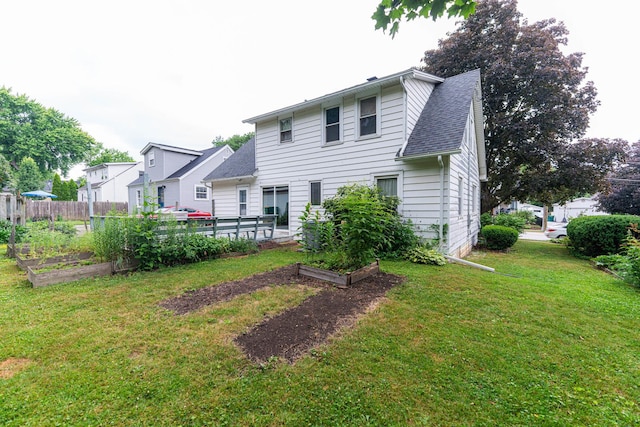536 Center Ave, Sycamore, IL 60178 - back of property with a vegetable garden and a shingled roof