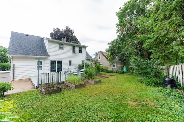 536 Center Ave, Sycamore, IL 60178 - back of property featuring a garden, roof with shingles, a chimney, and a patio
