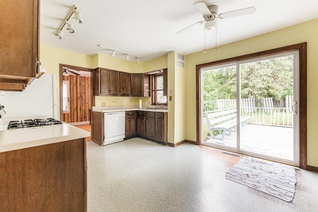 536 Center Ave, Sycamore, IL 60178 - kitchen with dishwasher, rail lighting, a ceiling fan, light countertops, and dark brown cabinetry